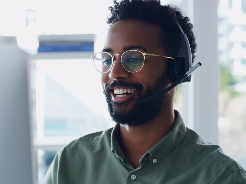 Smiling support team member wearing a headset